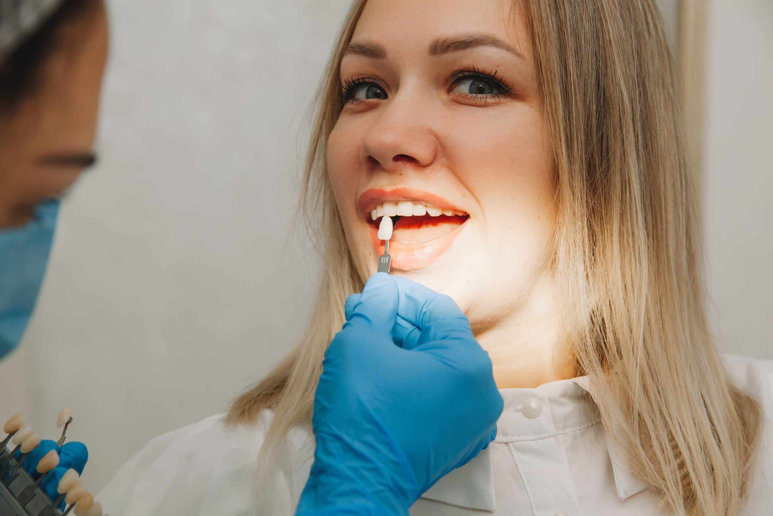 Cosmetic Dentist is matching the patient's tooth color